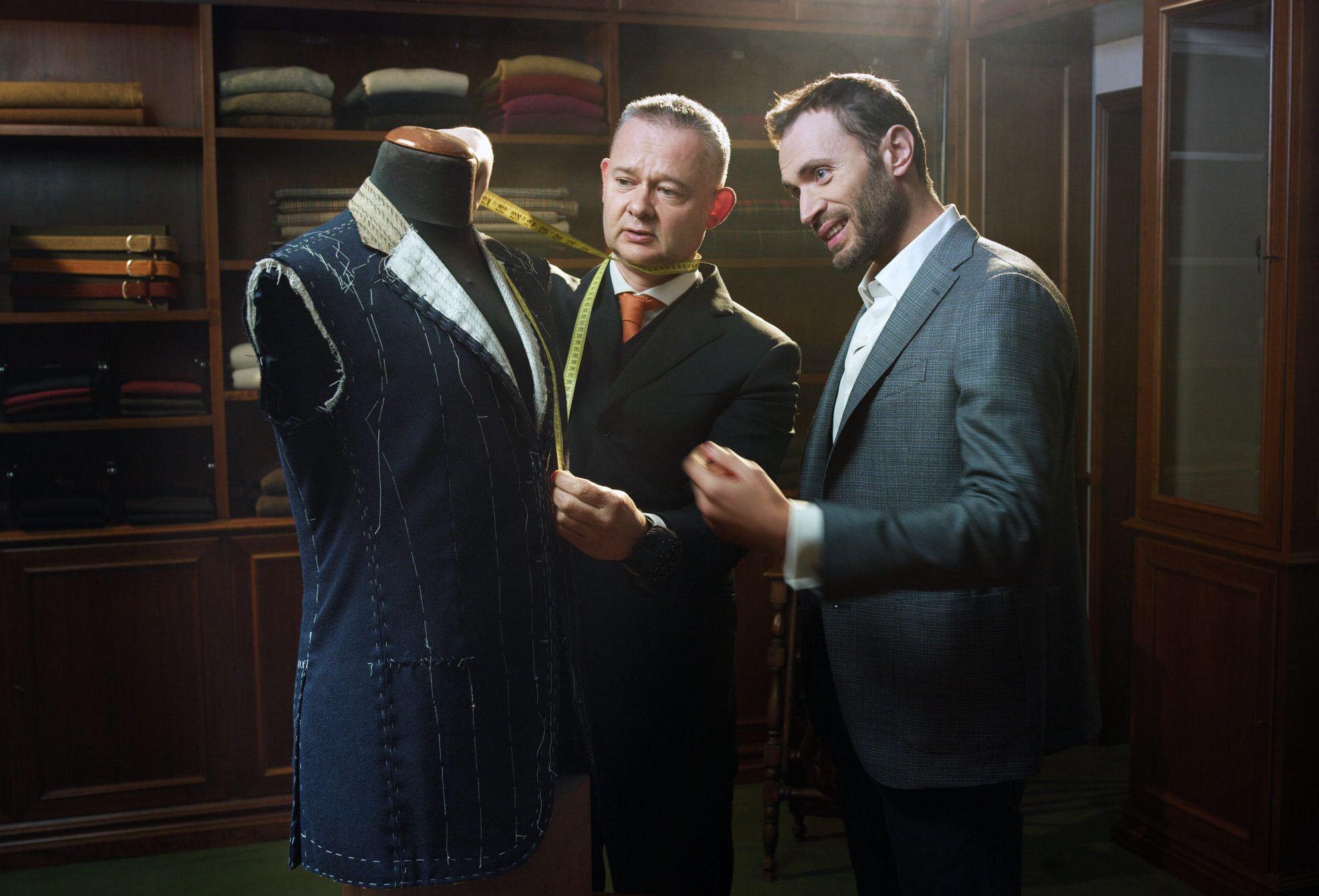 Tailor measuring a suit for a client, symbolizing customized solutions for HR quizzes.